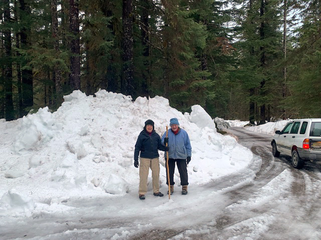 Standing in front of a pile of fresh winter with cousin Judy.